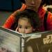 Two-year-old Hanako McDonald dressed as Darth Vader reads a Star Wars book with her mom at the Ann Arbor District Library on Saturday. Coordinators of the event explained they wanted it to be appropriate for all ages and provide a variety of activities. Daniel Brenner I AnnArbor.com